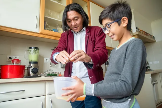 Two people cooking a meal together in a home kitchen